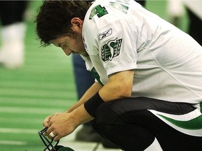 Dejected Saskatchewan Roughriders kicker Paul McCallum crouches on the sideline, alone with his thoughts, after missing an 18-yard field-goal attempt in the CFL's 2004 West Division final against the host B.C. Lions.