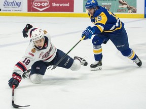 The Saskatoon Blades and Regina Pats will be scheduled to see a lot of each other once the WHL resumes in 2021. Here, Regina's Cole Dubinsky (18) reaches for the puck while being pursued by the Blades' Zach Huber (19) during a WHL hockey game at the Brandt Centre in Regina, Saskatchewan on Mar. 7, 2020. BRANDON HARDER/ Regina Leader-Post