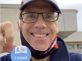 Rob Vanstone, who recently slept on and consequently tilted his glasses, displays an "I Voted" sticker outside the South Leisure Centre on Monday.