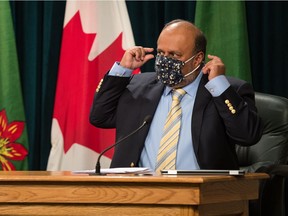 Saskatchewan's Chief Medical Health Officer Dr. Saqib Shahab speaks to a reporter about masks prior to a news conference at the Saskatchewan Legislative Building in Regina, Saskatchewan on Oct. 28, 2020.