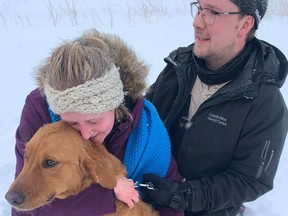 Julia and Brett Neufeldt are reunited with their dog Louie on November 11.