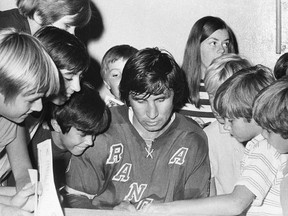 Jim Neilson of the New York Rangers signs autographs during his playing days.