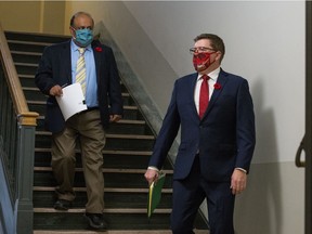 Chief medical health officer Dr. Saqib Shahab, left, and Premier Scott Moe hope the policy will help get Saskatchewan's COVID-19 surge under control.