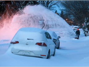 Saskatoon residents clear snow Monday morning after a the weekend's snow storm.