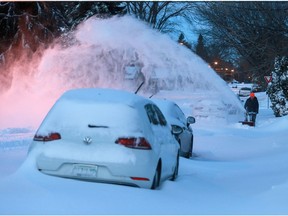 A Saskatoon resident clears snow following a record-breaking storm on Nov. 8, 2020.