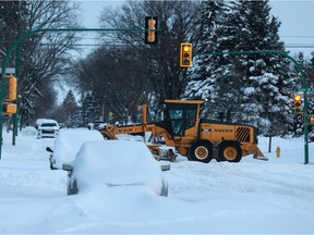 City workers get to work clearing snow off Taylor Street after a record-breaking snowfall in Saskatoon on Nov. 9, 2020.