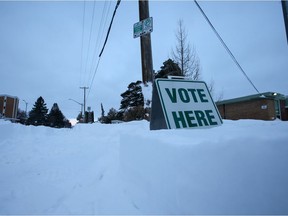 A 'Vote Here' sign is surrounded by snow on election day Monday morning after a record-breaking snow fall. Photo taken in Saskatoon, SK on Monday November 9, 2020.