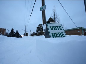 A 'Vote Here' sign is surrounded by snow on election day Monday morning after a record-breaking snow fall in Saskatoon on November 9, 2020. (Saskatoon StarPhoenix)