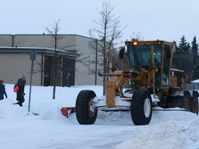 A city grater clears a street off of Taylor Street East on Nov. 9, two days after a blizzard hit Saskatoon.