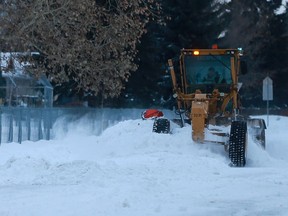 A City of Saskatoon grader clears snow off Taylor Street on Nov. 10, two days after a massive storm pummelled the city.