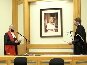 Court of Queen's Bench Chief Justice Martel Popescul administers the oath of office to Mayor Charlie Clark, who was re-elected to a second term on Friday, Nov. 13. The socially-distant swearing-in ceremony took place in the newly-renovated city council chamber on Monday, Nov. 16.