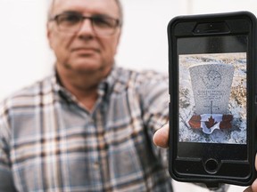 Dan Kirkpatrick shows a photo of a First World War soldiers' headstone he found at a cemetery in Avonlea, Sask. on Nov. 6, 2020. Kirkpatrick spent every weekend since March restoring the burial area. MICHAEL BELL / Regina Leader-Post