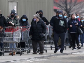 People line up at a Costco store in Winnipeg on Saturday.
