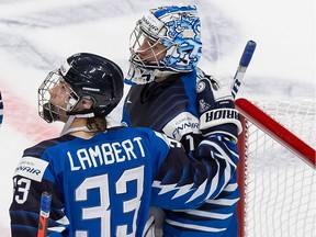 Finland's Brad Lambert (33) and goaltender Kari Piiroinen (1) celebrate their victory over Germany during the 2021 IIHF World Junior Championship at Rogers Place on Dec. 25, 2020 in Edmonton, Canada.