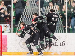 University of Saskatchewan's Sam Ruopp, Kohl Bauml, and Logan McVeigh smash into the glass to knock over a pyramid of cups in celebration of a Canada West conference championship win over the UBC Thunderbirds at Merlis Belsher Place on the U of S campus on Saturday, February 29, 2020 in Saskatoon.