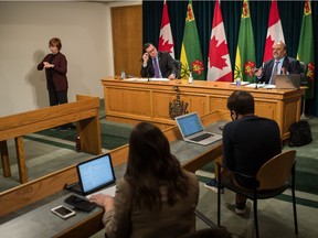 Saskatchewan's chief medical health officer Dr. Saqib Shahab speaks to media during a news conference regarding COVID-19 at the Saskatchewan Legislative Building in Regina, Saskatchewan on Nov 13, 2020. At centre is newly-minted Saskatchewan Health Minister Paul Merriman. On frame left is ASL interpreter Karen Nurkowski from Saskatchewan Deaf and Hard of Hearing.