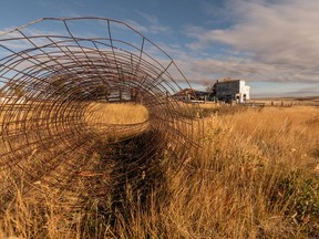 Unused fence wire sits in the grass near an abandoned house in Crichton, which sits along Saskatchewan's Highway 13, which has been nicknamed the "Ghost Town Trail."