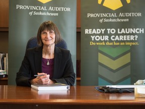 Provincial Auditor of Saskatchewan Judy Ferguson sits in her office with a copy of her most recent report in Regina, Saskatchewan on Dec. 8, 2020.
