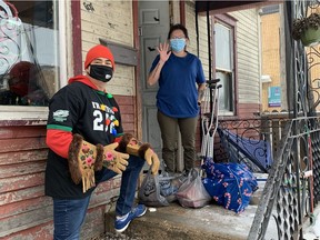 Joel Pedersen, left, delivering gifts to one of 15 families in Pleasant Hill Saturday. He, the Pleasant Hill Community Association and the Weyburn Canadian Tire, through the Jumpstart program, came together to provide the gifts. Courtesy of Joel Pedersen.