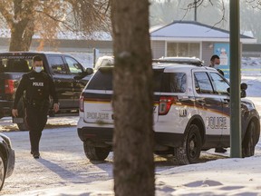 Saskatoon police officers at the 1100 block of Avenue W on Dec. 24, 2020 following a police-involved shooting.