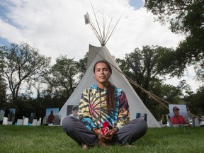 Tristen Durocher of Walking With Our Angels sits in front of the teepee where he mounted a hunger strike in Wascana Park across from the Saskatchewan Legislative Building in Regina, Saskatchewan on August 4, 2020.