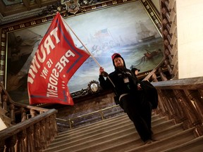 A protester holds a Trump flag inside the US Capitol Building near the Senate Chamber on January 06, 2021 in Washington, DC. Congress held a joint session today to ratify President-elect Joe Biden's 306-232 Electoral College win over President Donald Trump. A group of Republican senators said they would reject the Electoral College votes of several states unless Congress appointed a commission to audit the election results. (Photo by Win McNamee/Getty Images) ORG XMIT: 775604806