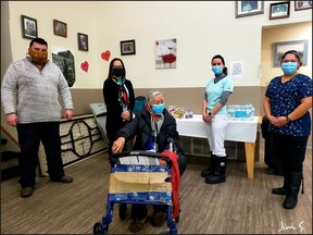 From left to right, Lac La Ronge Indian Band Councillor Devin Bernatchez, Chief Tammy Cook-Searson, Elder Florence Ratt, Laura Adam and Kristin McKenzie after vaccinating Ratt. Photo by provided Jim Searson on Jan. 12, 2021. (Saskatoon StarPhoenix)