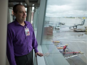 James Bogusz, president and CEO of the Regina Airport Authority, stands looking out at the tarmac at the Regina International Airport.