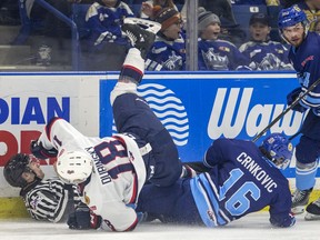 Saskatoon Blades forward Kyle Crnkovic and Regina Pats forward Cole Dubinsky hit the ice and take down a linesmen in the process during WHL action at SaskTel Centre in Saskatoon on Friday, March 6, 2020.