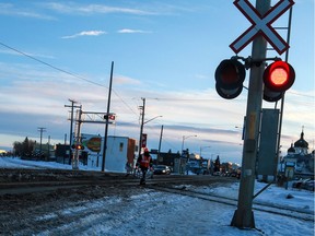 A CP Rail employee tests the lights at 20th Street West near Avenue L South after a collision involving a train and an Access Transit bus.