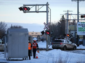 A CP Rail employee tests the lights at the 20th Street intersection near Avenue L South after there was a collision involving a train and an Access Transit bus. Photo taken in Saskatoon on Wednesday, January 20, 2021.
