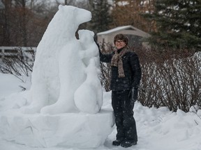 SASKATOON, SK--JANUARY 22/2021 - 0123 News Snow Sculpture - Saskatchewan sculptor Patricia Leguen stands with her sculpture "Bear Hug." Photo taken in Saskatoon, SK on Friday, January 22, 2021.