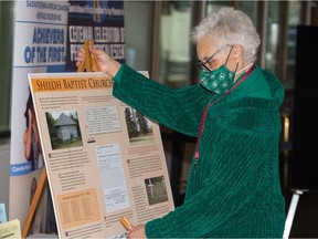 Carol LaFayette-Boyd, executive director of the Saskatchewan African Canadian Heritage Museum, sets up a display to mark Black History Month at the MacKenzie Art Gallery in Regina, Saskatchewan on Jan. 29, 2021.