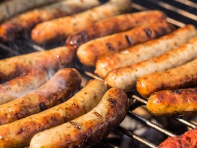 Sausages are pictured on a barbecue in a file photo.