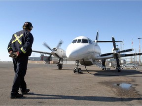A member of the ground crew personnel readies a West Wind Aviation plane at the Shell Aero Centre for a flight to Saskatoon.