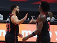 Jan 16, 2021; Tampa, Florida, USA; Toronto Raptors guard Fred VanVleet (23) and forward OG Anunoby (3) high five during the second half against the Charlotte Hornets at Amalie Arena. Mandatory Credit: Kim Klement-USA TODAY Sports