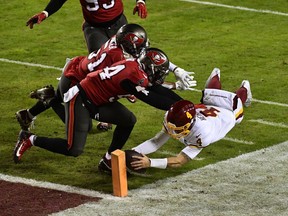 Washington Football Team quarterback Taylor Heinicke dives for the left front pylon to score on a nine-yard run during Saturday's NFL playoff game against the visiting Tampa Bay Buccaneers. Brad Mills/USA TODAY sports.