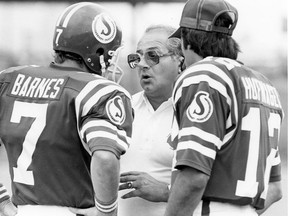 Saskatchewan Roughriders head coach Joe Faragalli talks with quarterbacks Joe Barnes, left, and John Hufnagel on Aug. 23, 1981. Barnes and Hufnagel formed an effective quarterbacking tandem — nicknamed J.J. Barnagel — during a season that led to Faragalli being named the CFL's coach of the year. Don Healy/Regina Leader-Post.