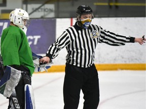 An on-ice game official wears a mask during a SJHL game played earlier this season. Photo by Susan McNeil
