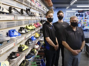 Dave Swain, right, stands with his sons Spencer, left, and Brayden, center, at Royal Sporting Goods. The family run business is in its fourth-generation.