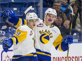 Saskatoon Blades forward Jaden Wiens, left, celebrates a goal with teammate Braden Plaschewsky during WHL action against the Calgary Hitmen in Saskatoon on Wednesday, March 4, 2020. The Blades haven't played a game since March 10, 2020.