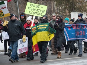 People march down Albert Street at what was billed as the Saskatchewan Freedom Rally that began at the Saskatchewan Legislative Building in Regina on Dec. 12, 2020.