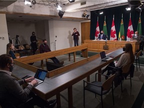 Saskatchewan  Premier Scott Moe, third from right, and chief medical health officer Dr. Saqib Shahab, right, take questions from media during a press conference regarding COVID-19, held at the Saskatchewan Legislative Building in Regina, Saskatchewan on Feb. 2, 2021.