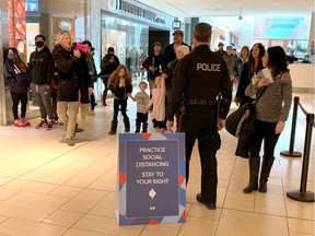 Police escort anti-mask protestors through Chinook Mall Saturday afternoon in Calgary on Saturday, February 13, 2021. Darren Makowichuk/Postmedia