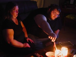 Christina Beverly and John Shearon light candles in their home after winter weather caused electricity blackouts and "boil water" notices in Fort Worth, Texas, U.S. February 20, 2021.