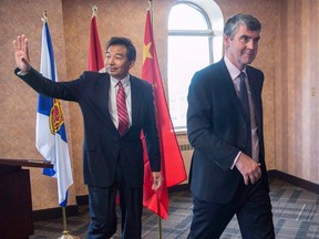 Luo Zhaohui, China's ambassador to Canada, waves as he and Nova Scotia Premier Stephen McNeil head from a meeting in Halifax on Thursday, April 28, 2016.