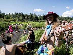 Boomlag performs beside Ness Creek as festival goers enjoy the water at the Ness Creek Music Festival near Nesslin Lake on July 20, 2019.