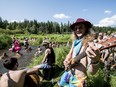 Boomlag performs beside Ness Creek as festival goers enjoy the water at the Ness Creek Music Festival near Nesslin Lake, SK on Saturday, July 20, 2019.