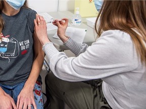 Registered nurse (RN) Kathy Pickerl receives the Pfizer Covid-19 vaccine from RN Cheryl Dow, becoming the second person in Saskatoon to receive the vaccine. Photo taken in Saskatoon, SK on Tuesday, December 22, 2020.