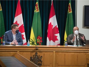 REGINA, SASK : March 2, 2021 -- Saskatchewan's chief medical health officer Dr. Saqib Shahab, right, speaks to reporters during a news conference regarding COVID-19, held at the Saskatchewan Legislative Building in Regina, Saskatchewan on Mar. 2, 2021. On frame left, Premier Scott Moe looks on. BRANDON HARDER/ Regina Leader-Post